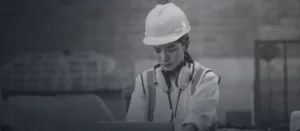 Manufacturing engineer working at a laptop on a factory floor