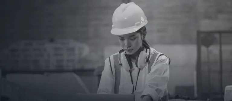 Manufacturing engineer working at a laptop on a factory floor